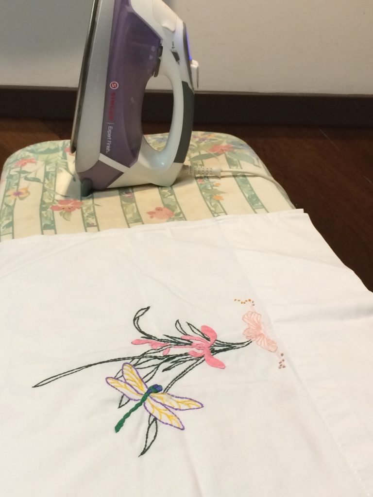 ironing a hand-embroidered pillow case